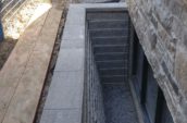 a retaining wall around a basement window