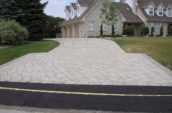 a brick driveway in front of a house